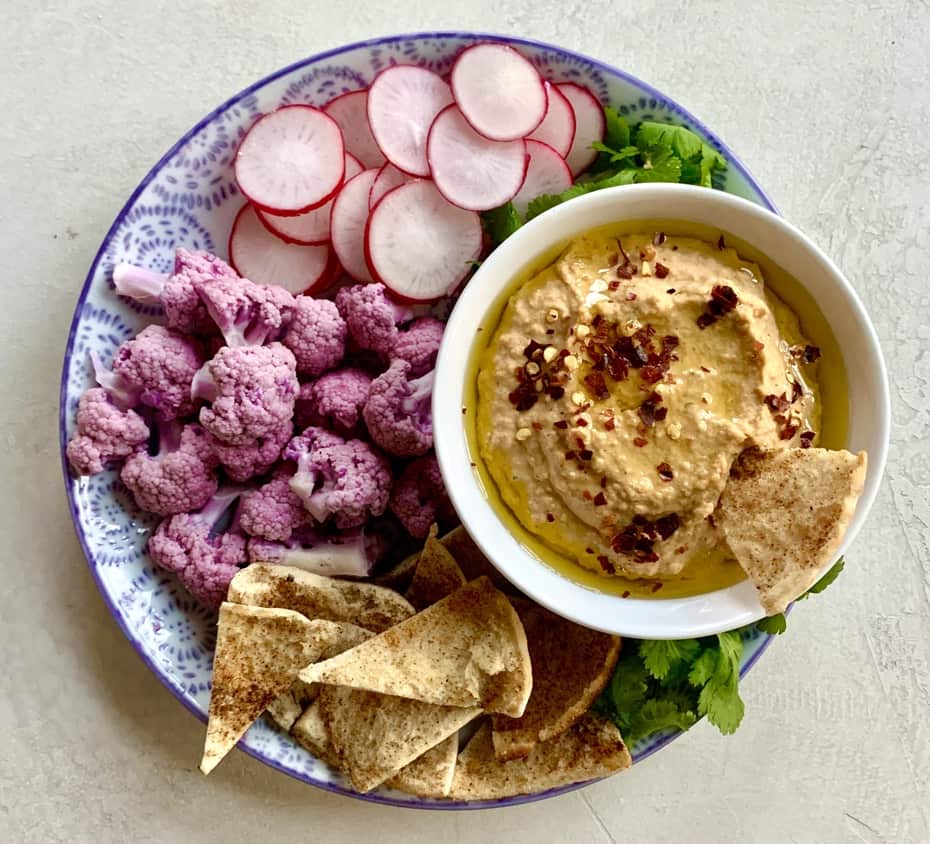 Roasted red pepper and garlic hummus with cauliflower, radishes, and pita bread