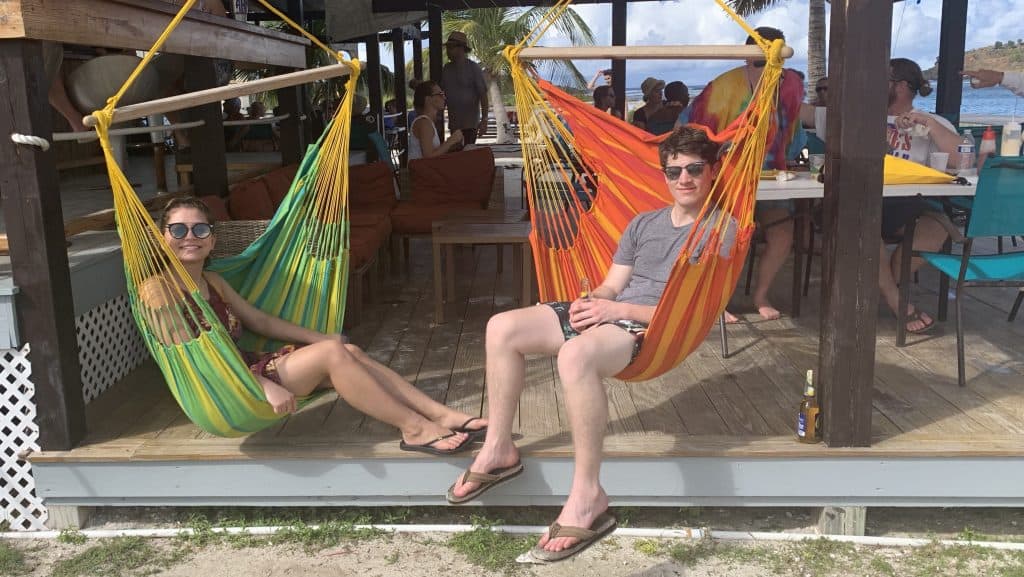 Two people relaxing in hammock swings