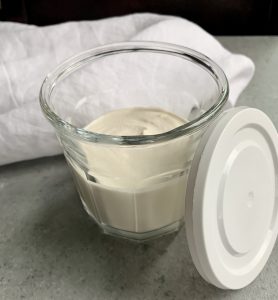 cashew cream freshly made and ready to store with a covered lid
