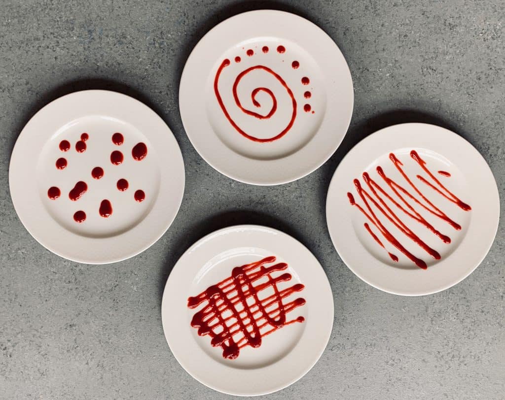 Plates decorated with raspberry coulis