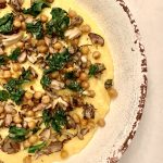 A large bowl of food with made with polenta, roasted mushrooms and chickpeas