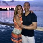 Chef Cindy pictured with her husband Rich and a colorful sky in Miami, waterside