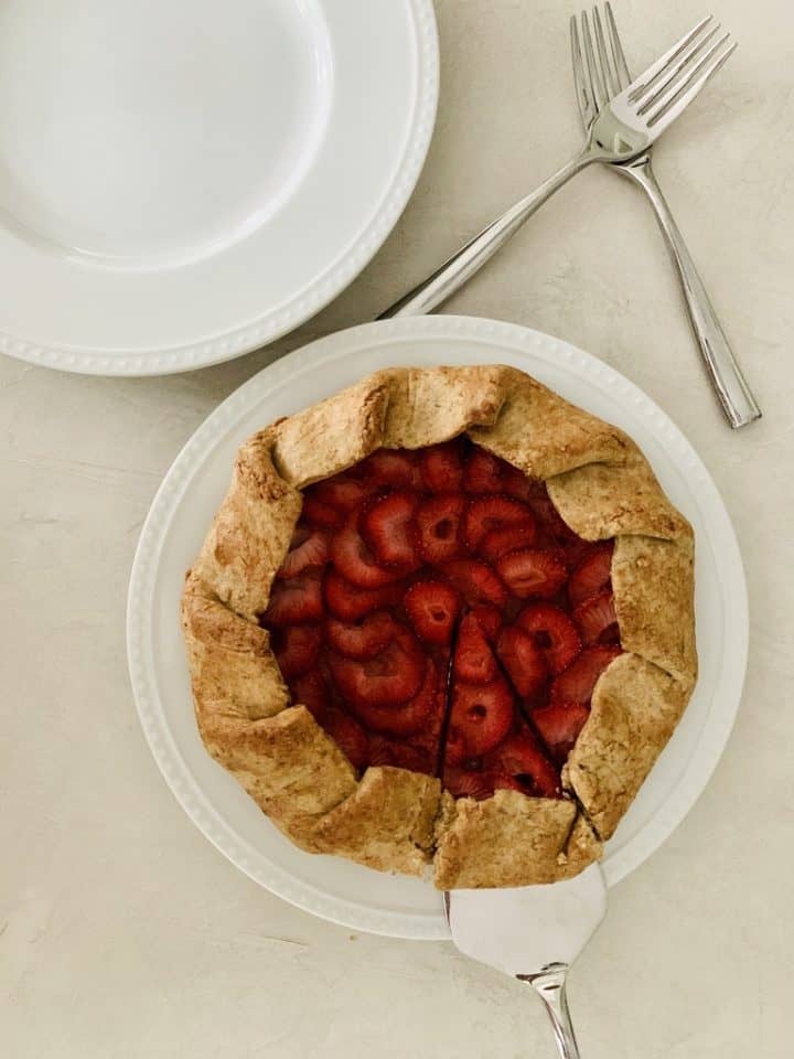 A plate of food on a table, baked with strawberry