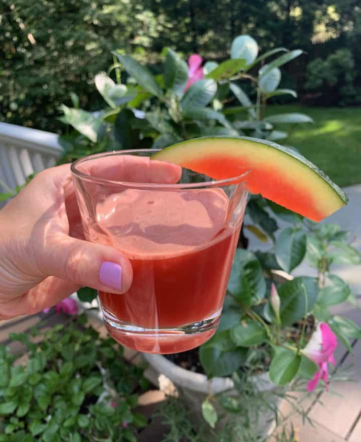 Watermelon Ginger Juice being held in a glass