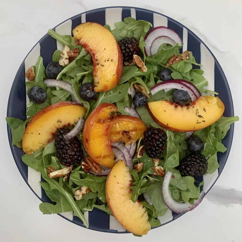 Grilled Peach Salad with Pecans beautifully plated topping with balsamic dressing