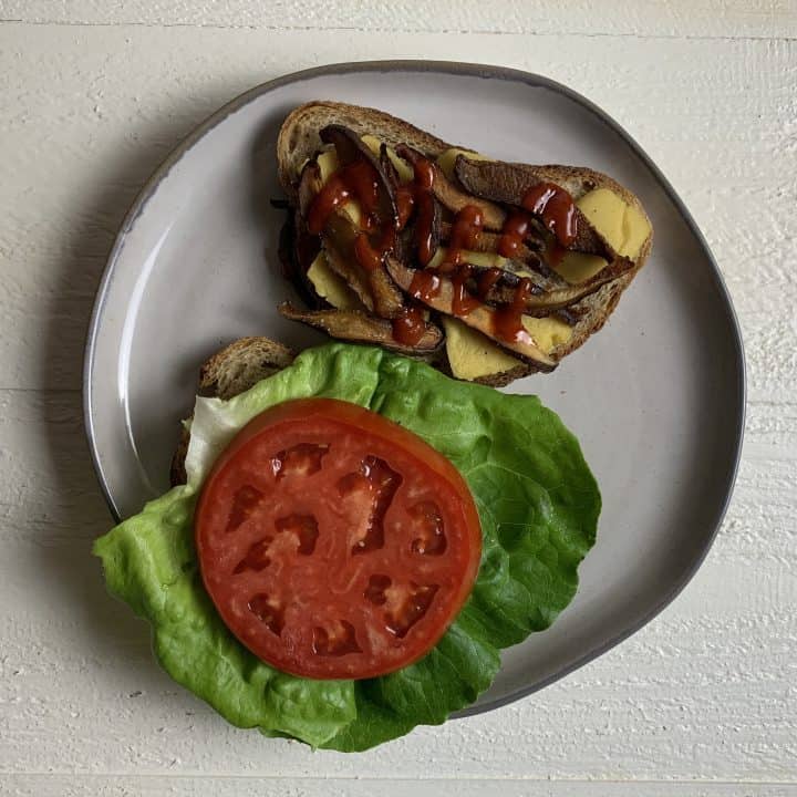 Vegan Shiitake BLT Sandwich with Almond Cheddar Cheese Sandwich open face on plate