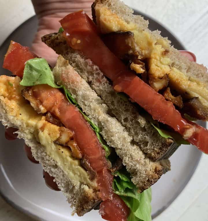 Vegan Shiitake BLT Sandwich sliced showing all the layered ingredients