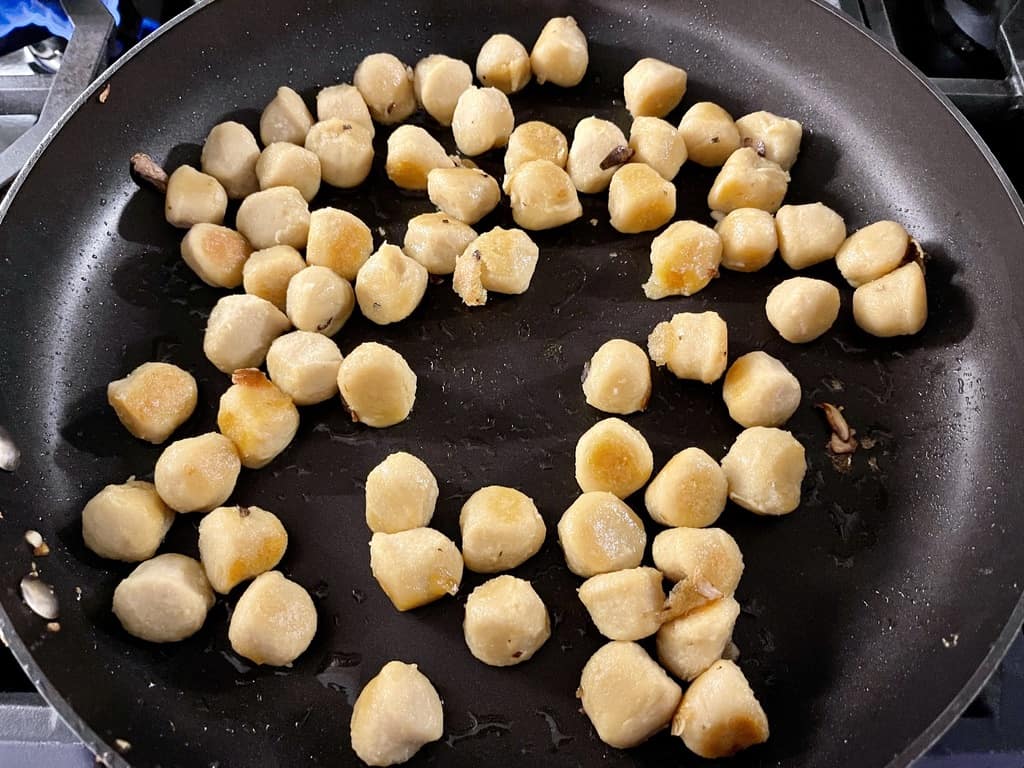 Cauliflower gnocchi cooking in a pan