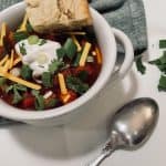 Maple Roasted Butternut Chili in bowl with toppings and cornbread