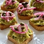 Brussels Sprouts Guacamole Appetizer shown close up topped with pickled red onions and capers