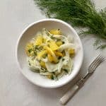 Shaved Fennel Citrus Salad in a bowl with fork and fresh fennel