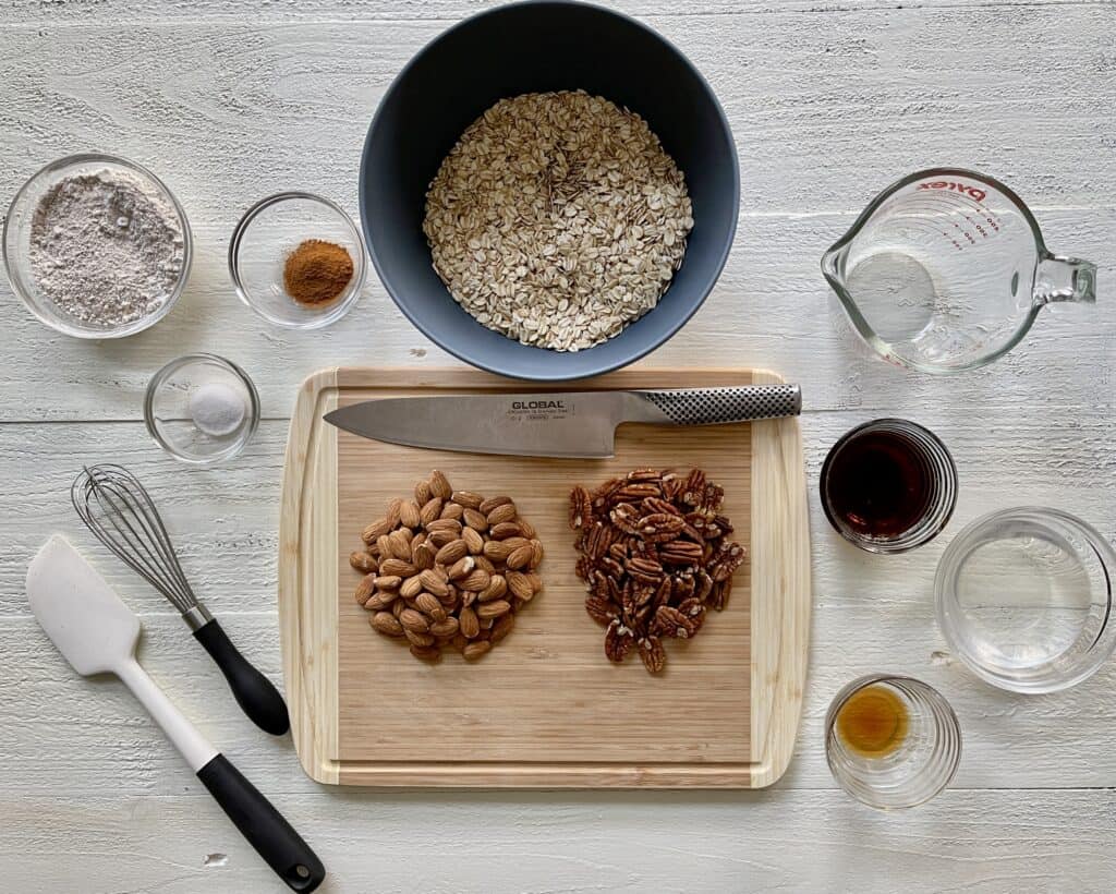 Best Granola Recipe Ingredients lined up in bowls and cutting board