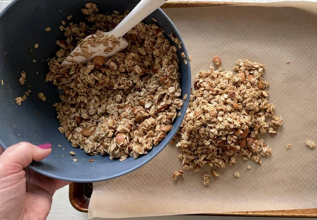 Best Vegan Granola ingredients blended together in a bowl and ready to spread on a baking sheet